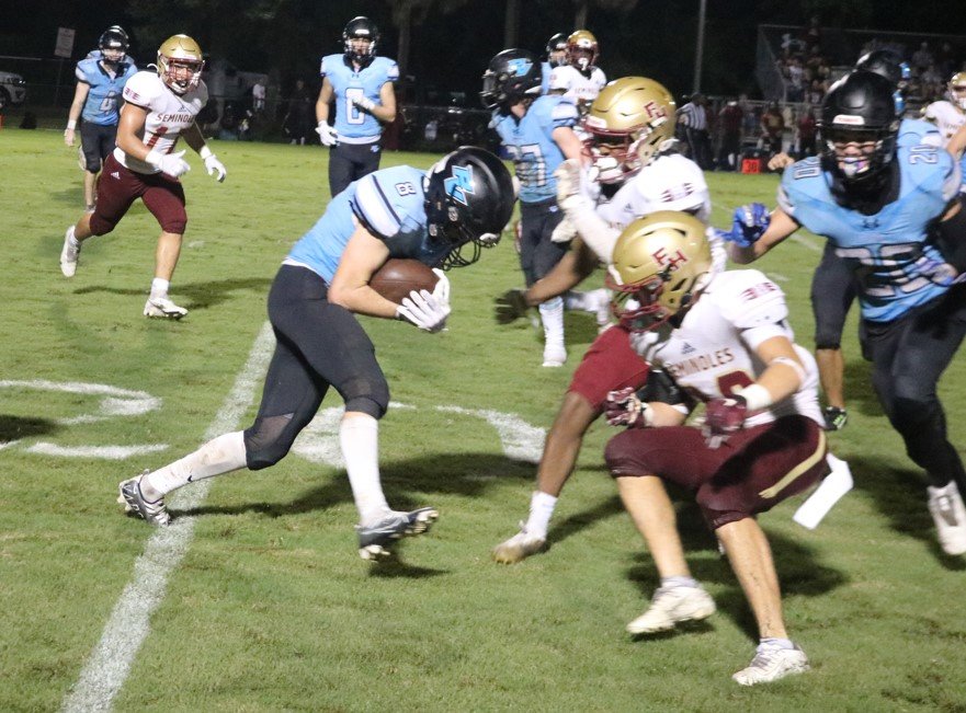 Ryan Smith fights for yards on the outside against Seminole defenders.